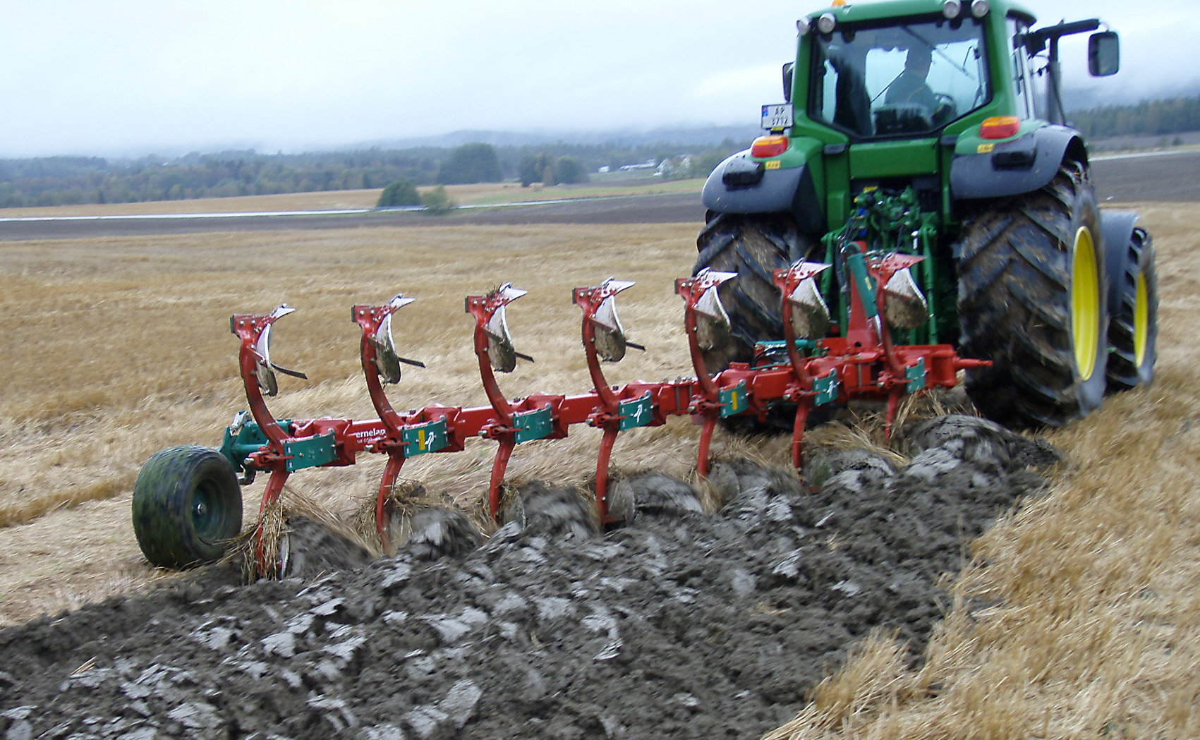 Plowing with a John Deere tractor and a Kverneland plough